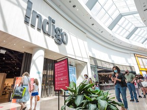 Shoppers wait in line to enter the Indigo store in Sherway Gardens mall during the stage two reopening in Toronto, Ont., June 30, 2021.
