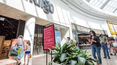 Shoppers wait in line to enter the Indigo store in Sherway Gardens mall during the stage two reopening in Toronto, Ont., June 30, 2021.