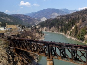 The charred remnants of the rail bridge, destroyed by a wildfire on June 30, is seen during a media tour by authorities in Lytton, British Columbia, July 9, 2021.