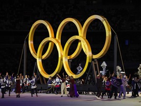 Performers assemble the Olympic Rings during the opening ceremony of the Tokyo 2020 Olympic Games, at the Olympic Stadium in Tokyo, on July 23, 2021.