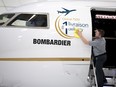 A Bombardier employee polishes the sign of Bombardier's Global 7500 business jet in 2018.