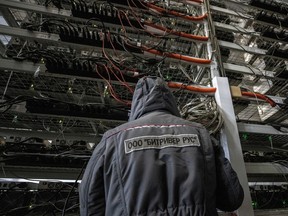 An employee works at the data centre of BitRiver company providing services for cryptocurrency mining in the city of Bratsk in Irkutsk Region, Russia.