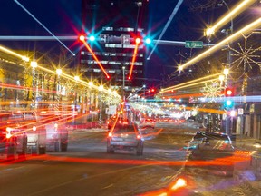 Traffic lights and vehicles streak through Grande Prairie’s downtown on 100 Avenue.