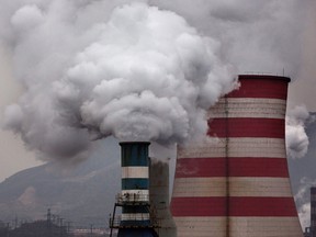 Smoke billows from smokestacks and a coal fired generator at a steel factory  in the industrial province of Hebei, China.