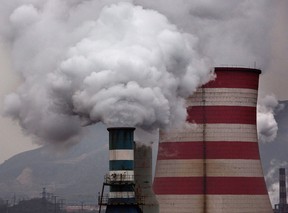 Smoke billows from smokestacks and a coal fired generator at a steel factory  in the industrial province of Hebei, China.