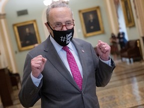 U.S. Senate Majority Leader Chuck Schumer emerges from the Senate chamber after the final passage of the infrastructure bill at the U.S. Capitol on Tuesday.
