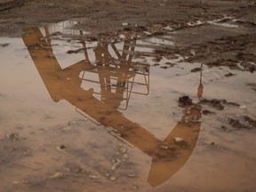 A coalbed methane well is seen reflected in a puddle in Jincheng, Shanxi province, China. The report says emissions "unequivocally caused by human activities" have already pushed the average global temperature up 1.1C from its pre-industrial average.