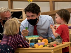Canada's Prime Minister Justin Trudeau plays with children at the daycare in Carrefour de l'Isle-Saint-Jean school in Charlottetown, Prince Edward Island last month. Ottawa has pledged to give parents access to $10-per-day child care within five years.