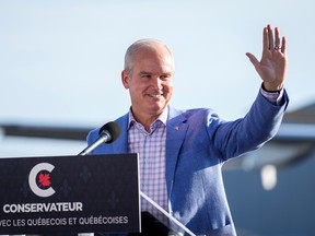 Conservative party leader Erin O'Toole waves during a speech at Chrono Aviation during his election campaign tour in Quebec City.