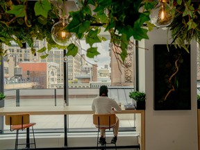 A lone employee at a cafe in Mastercard's new office, designed for hybrid work, in New York.