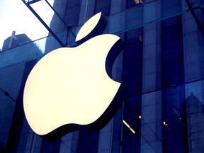 The Apple Inc.logo is seen hanging at the entrance to the Apple store on 5th Avenue in Manhattan, New York.