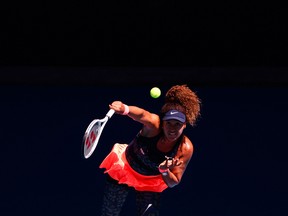 n this file photo taken on February 18, 2021, Japan's Naomi Osaka serves against Serena Williams of the US during their women's singles semi-final match on day eleven of the Australian Open tennis tournament in Melbourne.