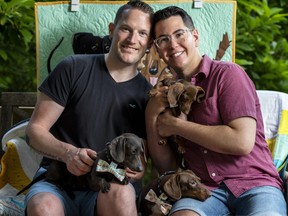 John MacPhail (left) and partner Matt pose with dachshunds and Art East Quilting Co. handmade goods.