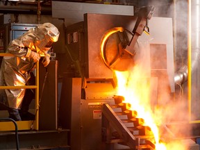 A worker at Agnico-Eagle’s Meadowbank mine pours gold.