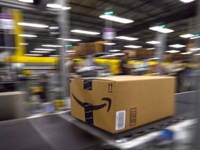 A box moves past on the conveyor for shipping inside the Amazon Fulfillment Centre in Brampton, Ontario. Amazon plans to hire 15,000 new warehouse and distribution employees across the country this fall.