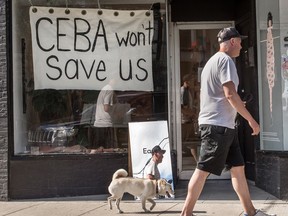 A store in Toronto displays a sign saying 'CEBA Won’t Help Us' during the COVID-19 pandemic. A recent Equifax Canada survey found that most small business owners do not feel supported by their banks and government.
