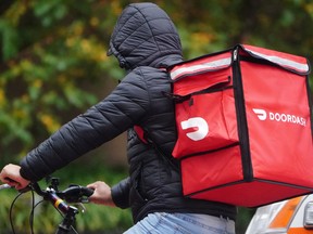 A delivery person for Doordash rides his bike in New York City. DoorDash Inc. is starting a dedicated alcohol delivery service.