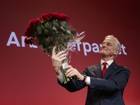 Labor leader Jonas Gahr Store holds a bouquet of red roses after the results of the Labor Party's election event in Folkets Hus, in Oslo, during the 2021 Norwegian parliamentary elections.