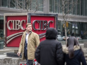 A man walks past the CIBC moniker on Bay Street at King Street in Toronto, Feb. 21, 2018.