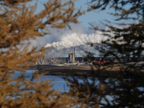 The Syncrude oil sands extraction facility behind a lake near the town of Fort McMurray, Alberta on Oct. 22, 2009.