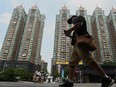 A man walking past a housing complex by Chinese property developer Evergrande in Guangzhou.
