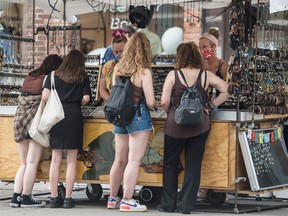Shoppers peruse a jewellery kiosk on Toronto’s Queen Street in August.
