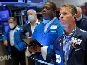 Traders work on the floor of the New York Stock Exchange in August.