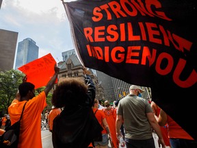 People march during the Every Child Matters walk in honour of children who lost their lives in Canada's Residential School system, in Toronto, on July 1, 2021.