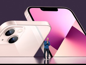 In this handout provided by Apple Inc., Apple CEO Tim Cook unveils the new iPhone 13 during an event at Apple Park on September 14, 2021 in Cupertino, California.