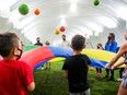 Prime Minister Justin Trudeau plays a game with children during a campaign stop in Hamilton, Ont.