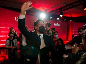 Prime Minister Justin Trudeau waves as he leaves leaves the Fairmount Queen Elizabeth Hotel after delivering his victory speech in Montreal, Quebec, early on September 21, 2021.