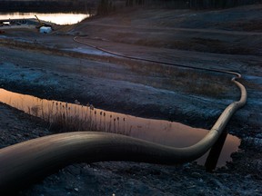 A water intake pipe for oilsands operations leads downhill to the Athabasca River.