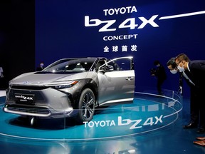 Visitors check a Toyota BZ4X Concept electric vehicle (EV) during its world premiere on a media day for the Auto Shanghai show in Shanghai, China April 19, 2021.