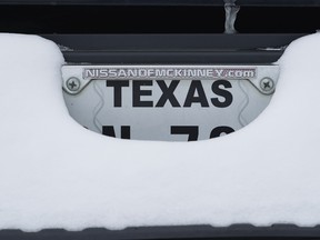 A license plate covered in snow on a truck in McKinney, Texas, U.S., on Tuesday, Feb. 16, 2021. The energy crisis crippled the U.S. last February as blackouts left almost 5 million customers without electricity, while refineries and oil wells were shut during unprecedented freezing weather.