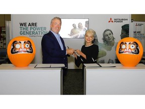 In a Japanese tradition, Paul Browning (L), Mitsubishi Power's President and CEO, and Kelly Tomblin, El Paso Electric's President and CEO, sign a joint development agreement to develop projects leveraging technologies that will enable El Paso Electric to attain its clean energy goals.