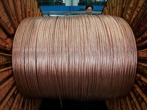 FILE PHOTO: An employee works at an electricity cable factory in Baoying, Jiangsu province, China