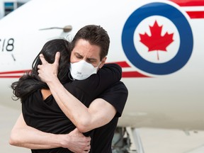 Former diplomat Michael Kovrig embraces his wife Vina Nadjibulla following his arrival on a Canadian air force jet after his release from detention in China, at Toronto Pearson International Airport in Toronto on Sept. 25.