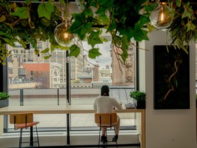 An employee sits at a cafe in the Mastercard office in the Flatiron District of New York, U.S., on Aug. 5, 2021.