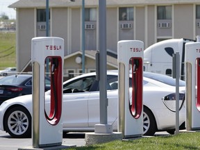 A Tesla charges at a station in Topeka, Kan., April 5, 2021.