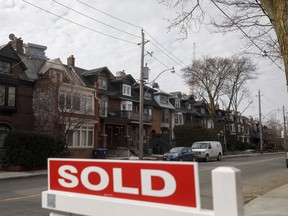 A sold sign in front of homes in the Midtown neighbourhood of Toronto on March 11, 2021.