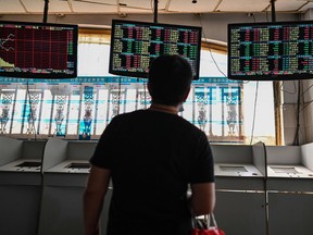 An investor monitors stock price movements at a securities company in Shanghai on Sept. 24, 2021.
