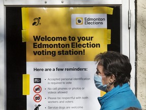 Edmontonians wait for the the advance polling station at the Hazeldean Community League to open in Edmonton on Oct. 4, 2021.