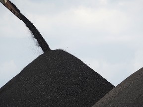 Coal is loaded onto a barge at a terminal operated by PT Bara Kumala Sakti in Kutai Kartanegara, East Kalimantan, Indonesia, on Oct. 13, 2021.