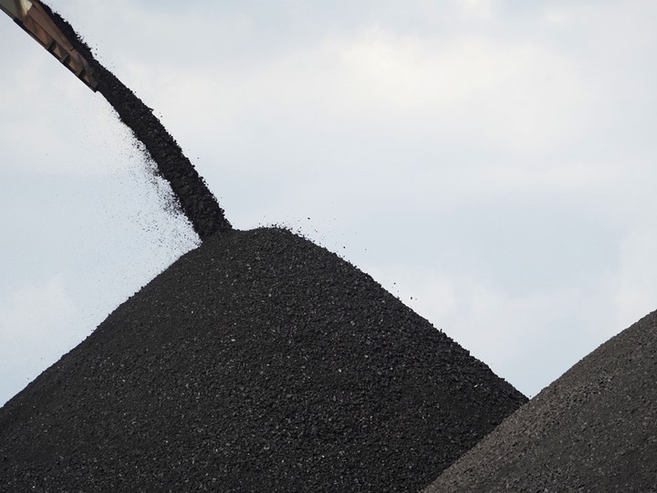  Coal is loaded onto a barge at a terminal operated by PT Bara Kumala Sakti in Kutai Kartanegara, East Kalimantan, Indonesia, on Oct. 13, 2021.