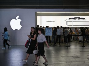 People visit an Apple store in Shanghai on Oct. 5, 2021.