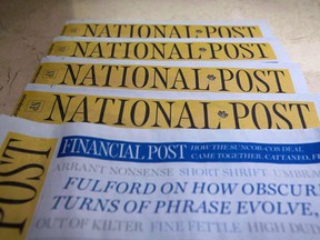 Copies of the Postmedia-owned newspaper National Post are displayed in Burnaby, B.C., on Jan. 19, 2016.