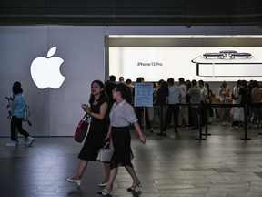 People visit an Apple store in Shanghai on Oct. 5, 2021.