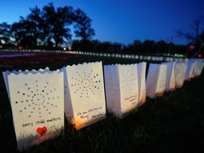 Candles on paper bags with messages during a vigil on Canada's first National Day for Truth and Reconciliation at Chiefswood Park in Ohsweken, Ont. on Sept. 30, 2021.