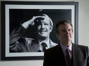 Edward Rogers in Rogers Communications' Toronto office with a photo of his father Ted Rogers in the background. The corporate family feud at one of Canada's biggest telecom companies is escalating.