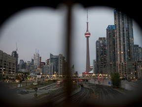The CN Tower, centre, stands near residential and commercial buildings in the financial district of Toronto.